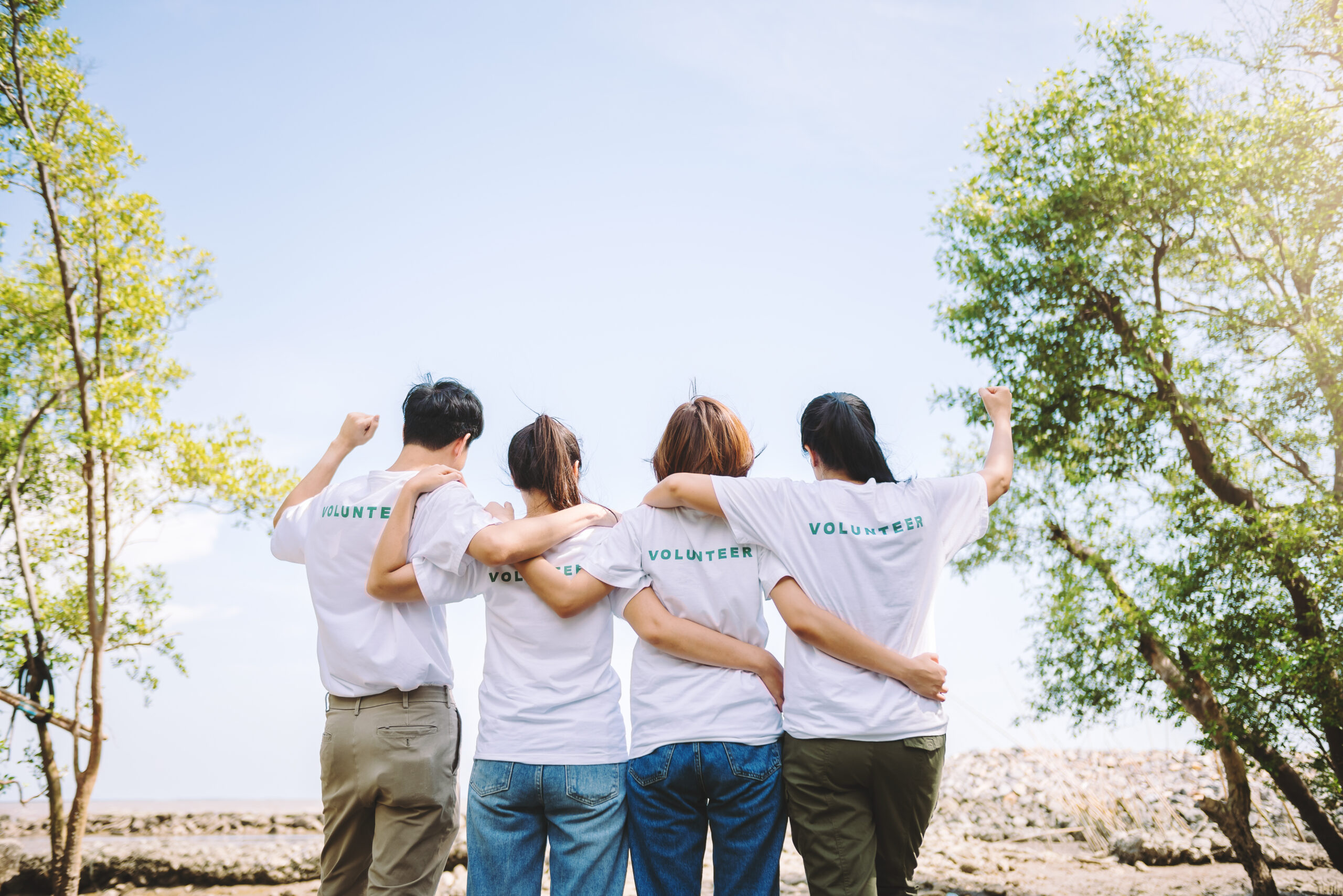 Group of Asian diverse people volunteer teamwork joining to success the goal on charity event ,Unity and teamwork on world environment day.